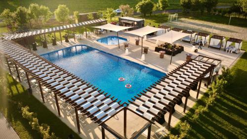 an overhead view of a swimming pool with benches at Casa Vlasia in Snagov