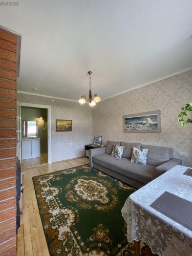 a living room with a couch and a rug at Tulika korter in Paralepa