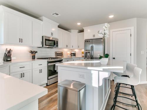a kitchen with white cabinets and a white counter top at New Dream Home in Broken Arrow! in Broken Arrow