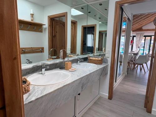 a bathroom with two sinks and a large mirror at Casas Lapa in Costa Teguise
