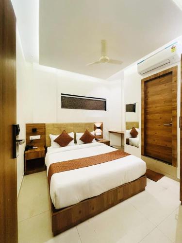 a bedroom with a large bed in a room at HOTEL BLACK BURN in Mumbai