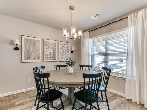 a dining room with a table and chairs at Spacious Retreat with Vaulted Ceilings & Primary Suite! in Broken Arrow