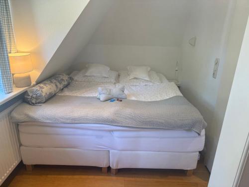 a bed with a stuffed animal on it in a room at Doppelzimmer am Park in Bremerhaven