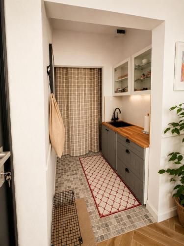 a kitchen with a sink and a counter top at LOG apartament in Dobrzewino
