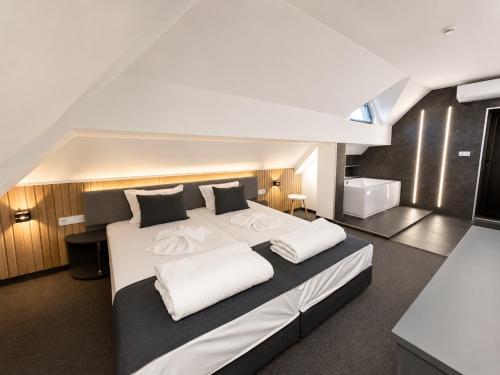a bedroom with a large bed with two white pillows at Adeti Residence in Nesebar
