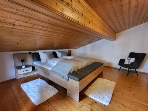 ein Schlafzimmer mit einem großen Bett und einer Holzdecke in der Unterkunft Waldglanz Loft in Freyung
