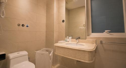 a bathroom with a sink and a toilet at Eliana Hotel in Al Khobar
