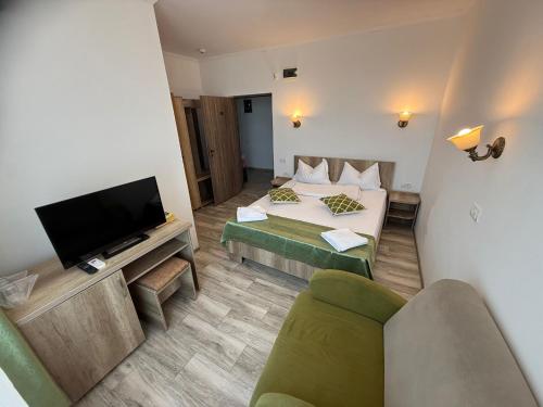 a living room with a couch and a tv at Complex Turistic Perla Venusului in Venus