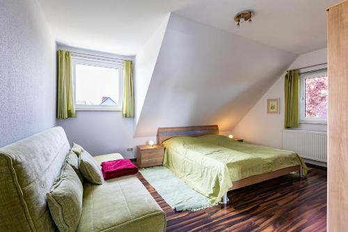 a bedroom with a bed and a couch at Carpe Diem in Wieck
