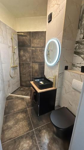 a bathroom with a sink and a mirror at Dana Residence in Floreşti