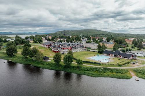 an aerial view of a large building next to a river at Grand Arctic Resort in Överkalix