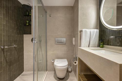 a bathroom with a toilet and a shower and a sink at Side Star Beach Hotel - Ultra All Inclusive in Side