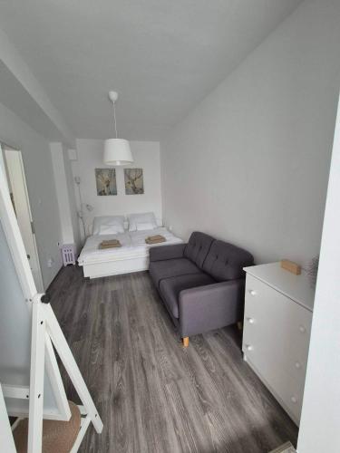 a living room with a couch and a bed at Green Terrace Residence in Zalaegerszeg
