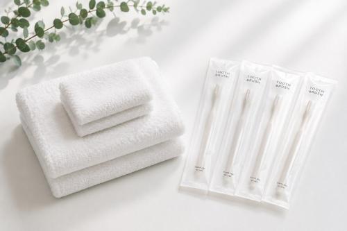 two white towels sitting on top of a table at MOTOBU Ocean Private Villa in Motobu