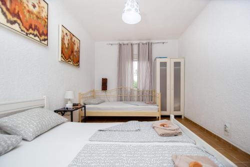 a bedroom with two beds and a window at Apartments Mia Patria in Ulcinj