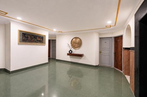 a hallway with white walls and a painting on the wall at FabHotel Le Sancy in New Delhi