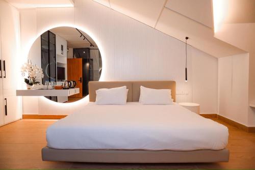 a bedroom with a large white bed in a room at Arados Resort in Bdibbā