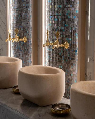 three sinks on a counter in a bathroom at Arados Resort in Bdibbā