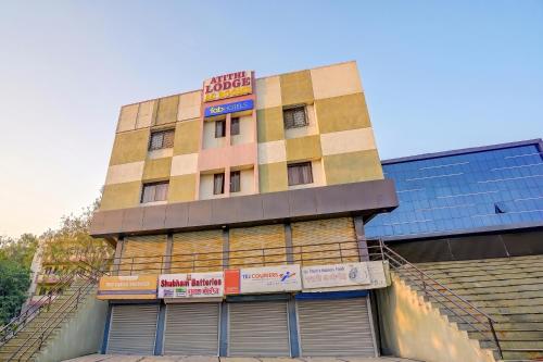 a building with a sign on the side of it at FabHotel Wagholi Inn in Pune
