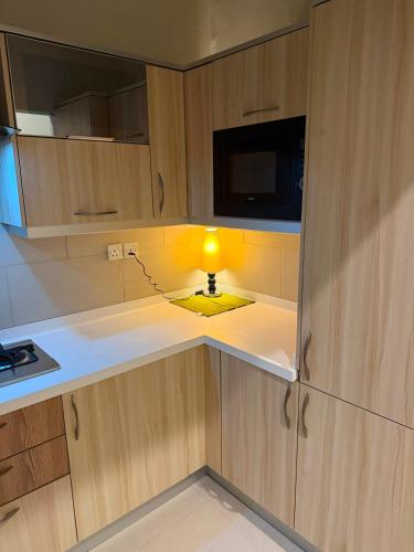 a lamp sitting in the middle of a kitchen at Private & Serene Golf View Apt Phase 7 in Rawalpindi