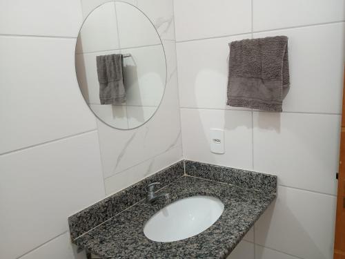 a bathroom with a sink and a mirror at Parque Ecológico - Studio 3 - Térreo in Indaiatuba