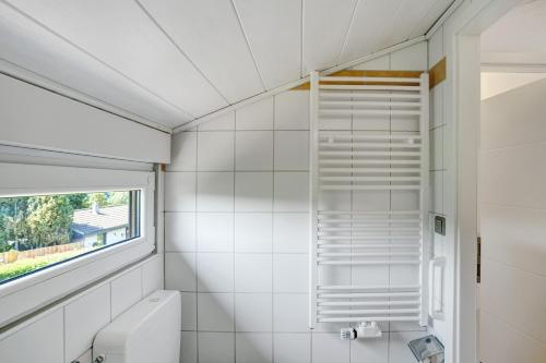 a bathroom with a toilet and a window at Ferienhaus Bianca in Meschede