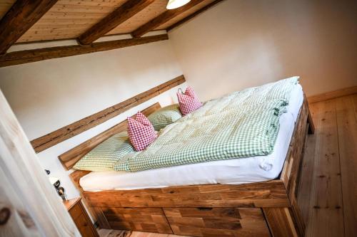 a bed with two pillows on it in a room at Berghof Papstdorf in Kurort Gohrisch