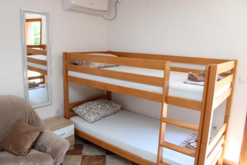 a bunk bed in a room with a mirror at Bellora Studio House in Donja Jošica