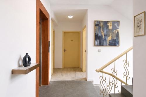 a hallway with a staircase with a yellow door at FabHotel Amar Residency, Sector 7, Dwarka in New Delhi