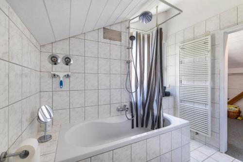 a bathroom with a tub and a shower at Panoramablick Loft & Aktiv-Urlaub in Lichtenstein