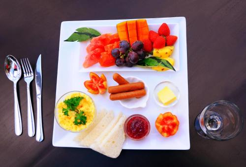 a plate of food with fruits and vegetables on a table at City Stay in Galle