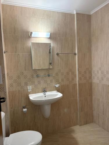 a bathroom with a sink and a toilet and a shower at Cattleya in Nesebar