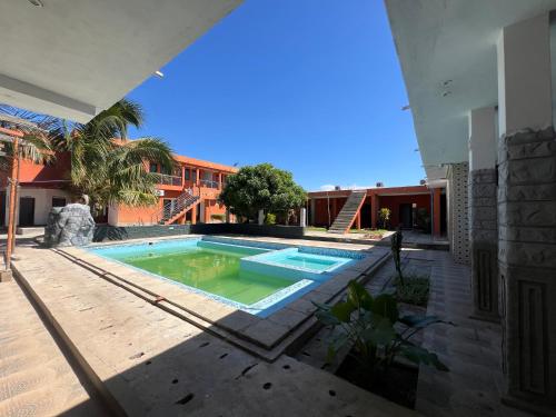 a swimming pool in the backyard of a house at Hotel Residencial Assamar in Pemba