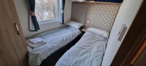 a small room with two beds and a window at Beauport Retreat in Hastings