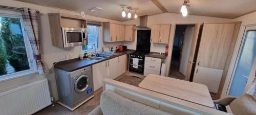 a small kitchen with a stove and a sink at Beauport Retreat in Hastings