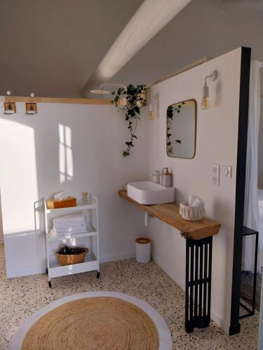 a bathroom with a sink and a mirror at La Villa 1777 in Lagnes