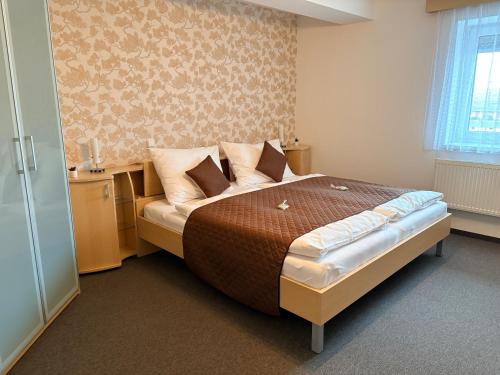 a bedroom with a large bed in a room at Hotel Senimo in Olomouc