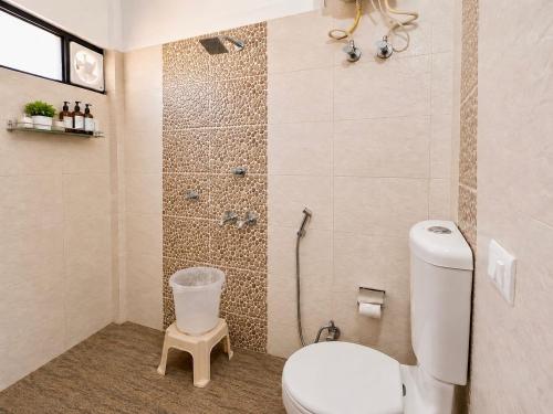a bathroom with a toilet and a shower at The Hills Boho in Mukteshwar