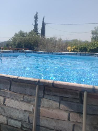 a large swimming pool with blue water at Edem House - Volos Greece in Volos