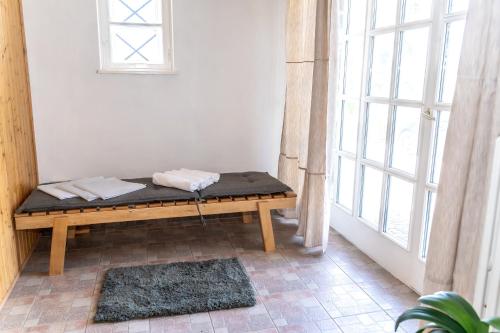 a bench sitting in a room with a window at Vila Vlasta in Bruntál
