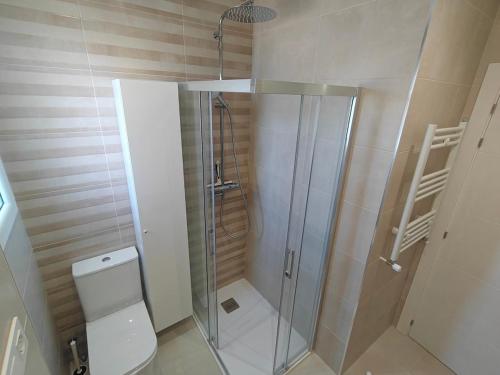 a bathroom with a shower and a toilet in it at El Sol de la Paz in Haro