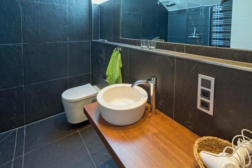 a bathroom with a sink and a toilet at Ferienwohnung Loft in Strandnähe in Norden