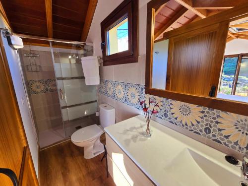 a bathroom with a toilet and a sink at Los Nacientes Vega in Los Sauces