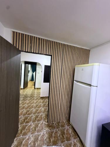 a room with a refrigerator and a hallway at Hypnotic Suite 1 in Piteşti
