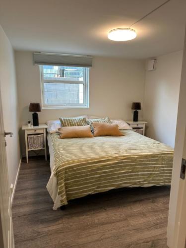 a bedroom with a large bed with pillows on it at Cozy apartment in Tananger close to the Airport in Tananger