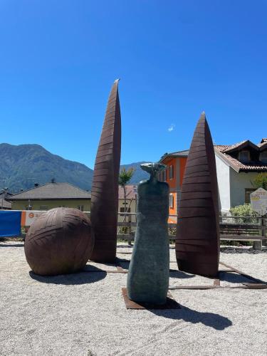 a group of sculptures sitting on the ground at SecretGarden - Levico Terme in Levico Terme