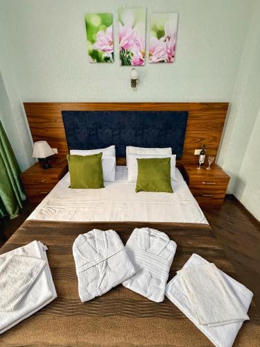 a bedroom with a bed with two towels on it at Golden Fleece Hotel in Ureki