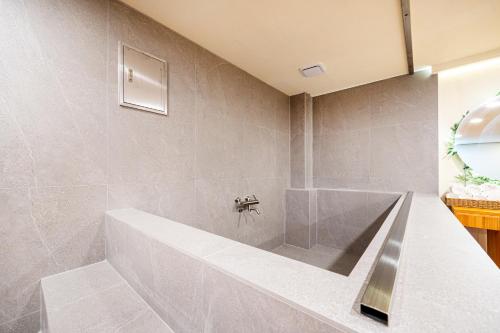 a bathroom with a tub and a sink at Hotel Traum in Gapyeong