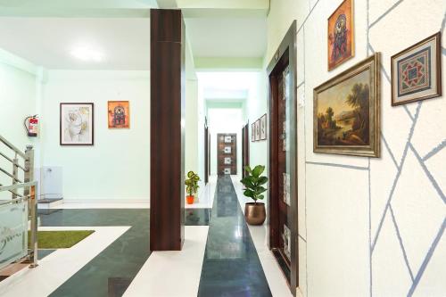 a hallway with paintings on the walls at FabHotel Skyview in Bhopal