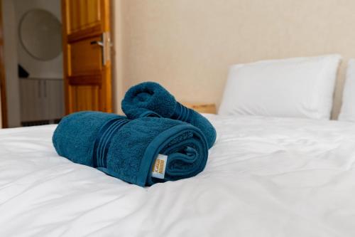 a blue towel laying on top of a bed at KASA GUEST Tamraght in Tamraght Ouzdar